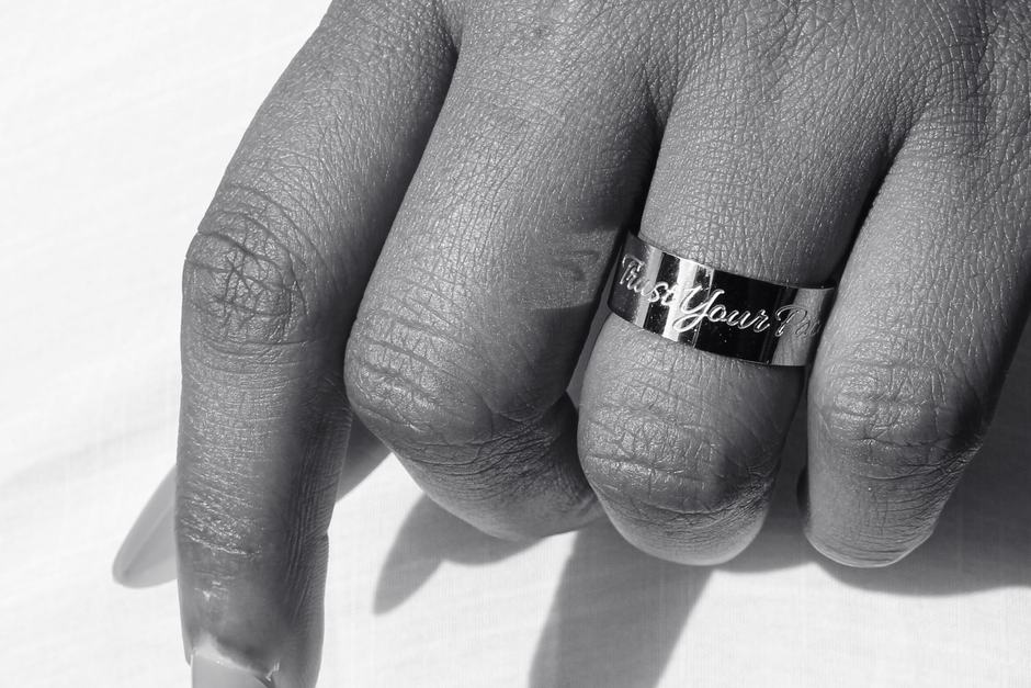 A silver engraved band, black and white.