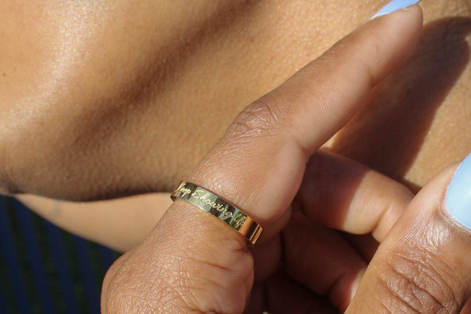 An engraved gold band catching the light.