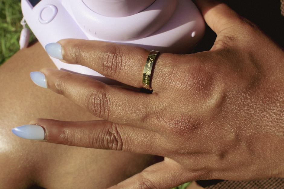 A ring worn while holding an instant camera.